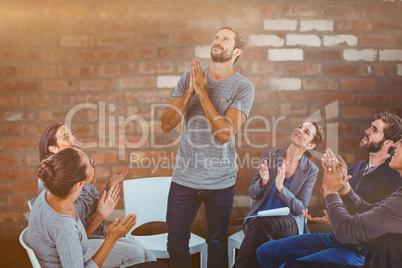 Composite image of rehab group applauding delighted man standing