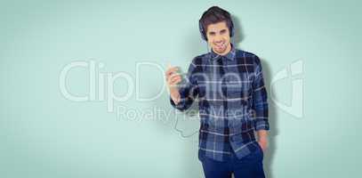 Composite image of portrait of happy hipster wearing headphones