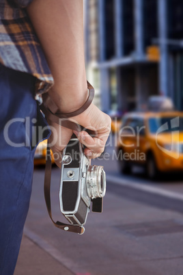 Composite image of cropped image of man holding camera