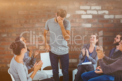 Composite image of rehab group applauding delighted man standing