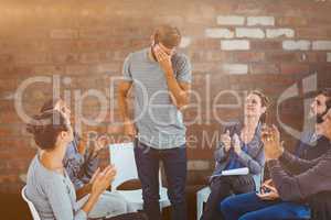 Composite image of rehab group applauding delighted man standing