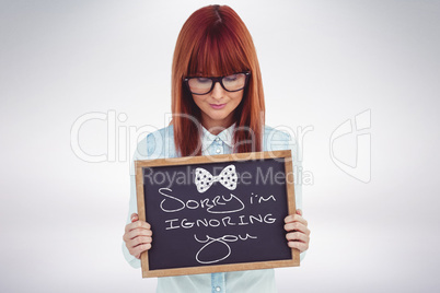 Woman holding small blackboard