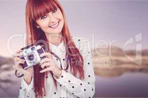 Attractive smiling hipster woman with old fashioned camera