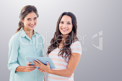 Composite image of smiling businesswoman with tablet