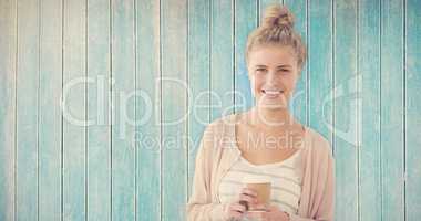 Composite image of portrait of smiling woman holding coffee cup