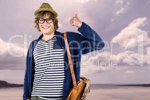 Composite image of smiling hipster making thumbs up