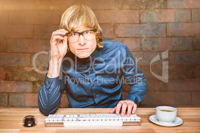 Composite image of focused hipster businessman using computer