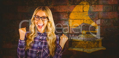 Composite image of gorgeous blonde hipster celebrating success