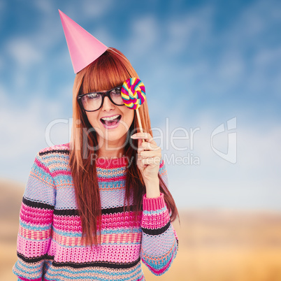 Composite image of smiling hipster woman with lollipop and hat p