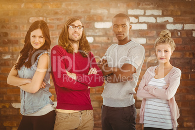 Composite image of portrait of business team with arms crossed