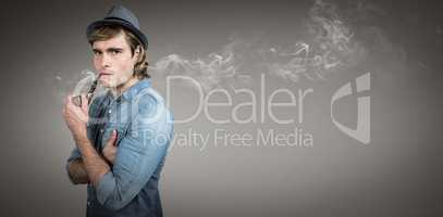 Composite image of serious hipster smoking pipe