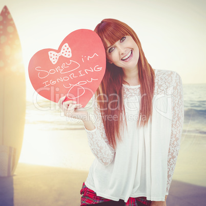 Woman holding a heart shaped sign in her hands