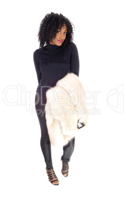 African American woman with fur coat over arm.