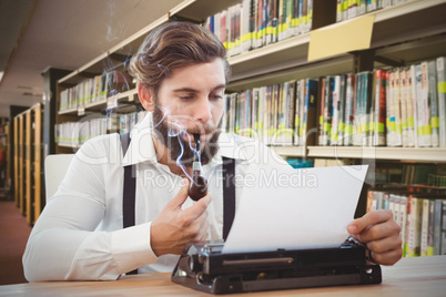 Composite image of hipster with smoking pipe working on typewrit