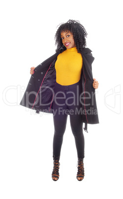 African American woman in yellow sweater and coat.