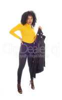 African American woman sweater holding her coat.