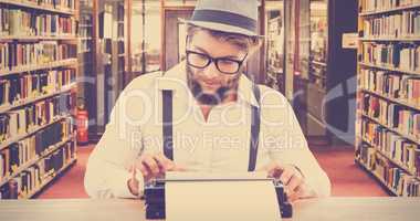 Composite image of hipster wearing eye glasses and hat working o