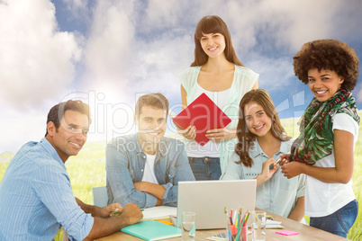 Composite image of smiling casual colleagues in a meeting