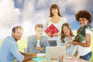 Composite image of smiling casual colleagues in a meeting