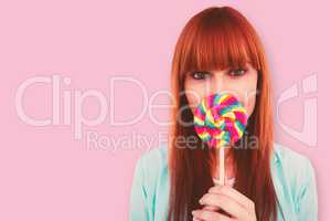 Composite image of smiling hipster woman with a lollipop