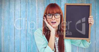 Composite image of smiling hipster woman holding blackboard