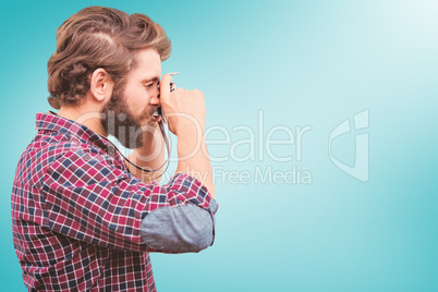 Composite image of side view of hipster photographing with camer