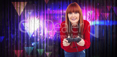 Composite image of smiling hipster woman playing video games