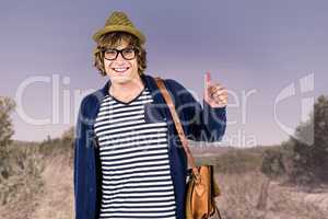 Composite image of smiling hipster making thumbs up