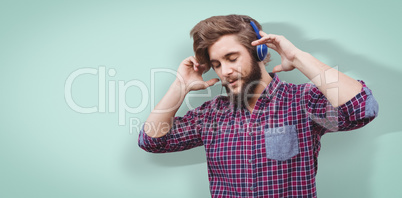 Composite image of hipster wearing headphones