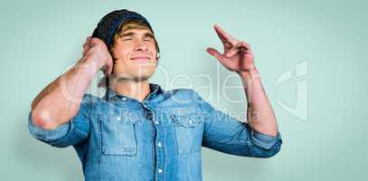 Composite image of cheerful hipster listening to music