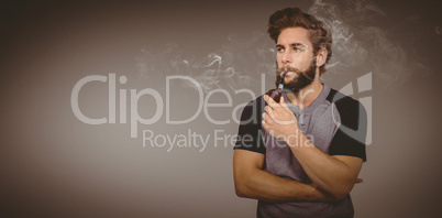 Composite image of confident hipster smoking pipe