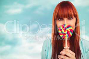 Composite image of smiling hipster woman with a lollipop