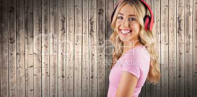 Composite image of portrait of a beautiful young woman with headphones