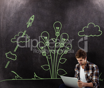 Composite image of hipster working on laptop