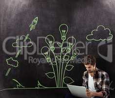 Composite image of hipster working on laptop