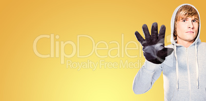 Composite image of man with black gloves staring at camera