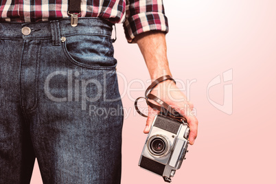 Composite image of hipster man holding digital camera