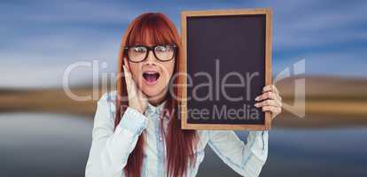 Composite image of smiling hipster woman holding blackboard