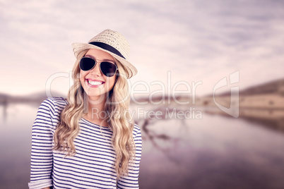 Gorgeous smiling blonde hipster with sunglasses and straw hat