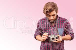 Composite image of hipster using camera