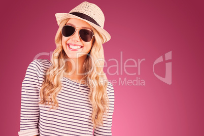 Composite image of gorgeous smiling blonde hipster with sunglass