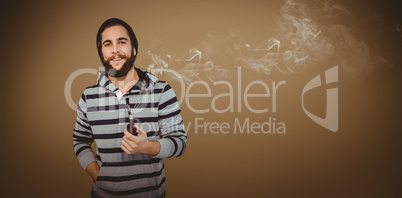 Composite image of happy hipster with hooded shirt holding smoki