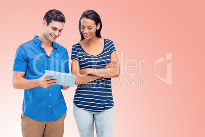 Composite image of smiling persons using tablet