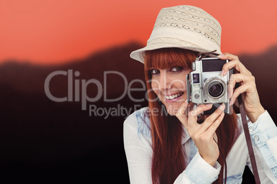 Composite image of attractive hipster photographing with camera