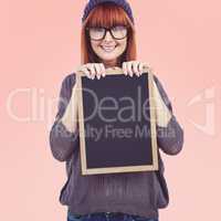 Composite image of smiling hipster woman holding blackboard