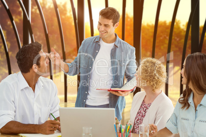 Composite image of group of young colleagues in a meeting