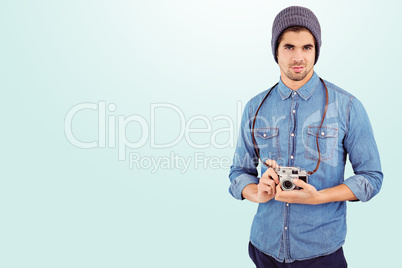Composite image of portrait of confident  hipster using camera