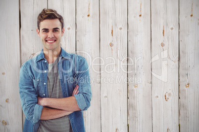 Composite image of smiling creative businessman by his desk