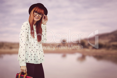 Smiling hipster woman holding book belt