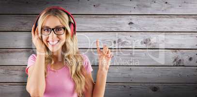 Composite image of portrait of a young hipster listening to music